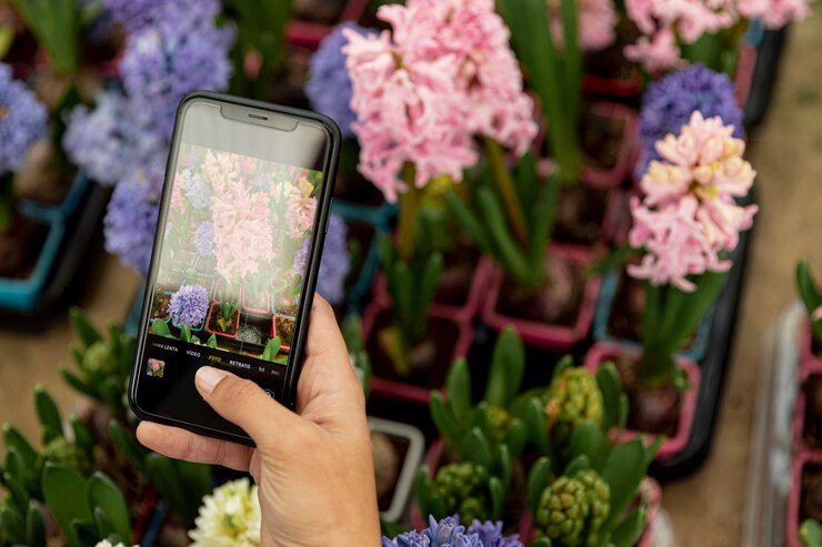 close-up-woman-taking-photo-flowers_23-2148447139