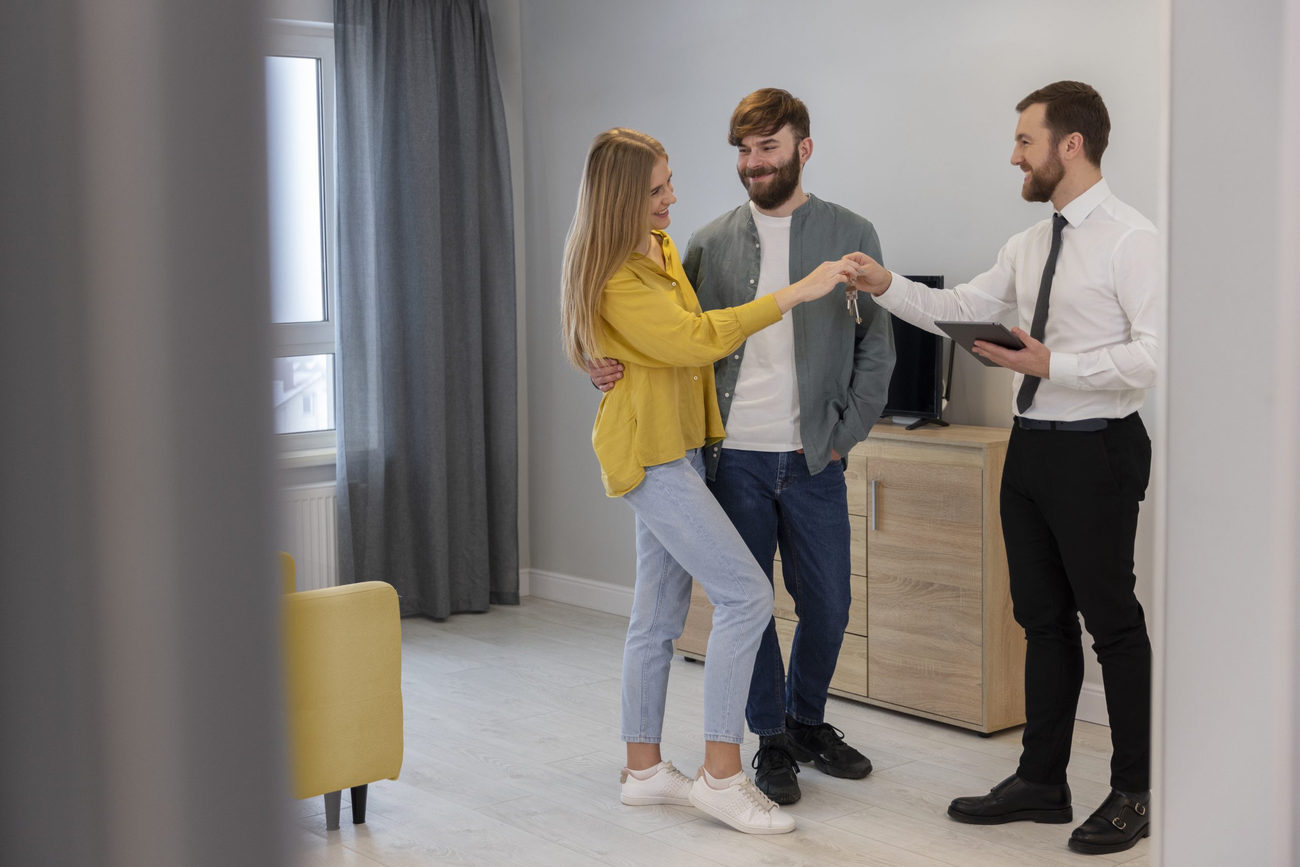 male-real-estate-agent-doing-business-showing-house-potential-buying-couple