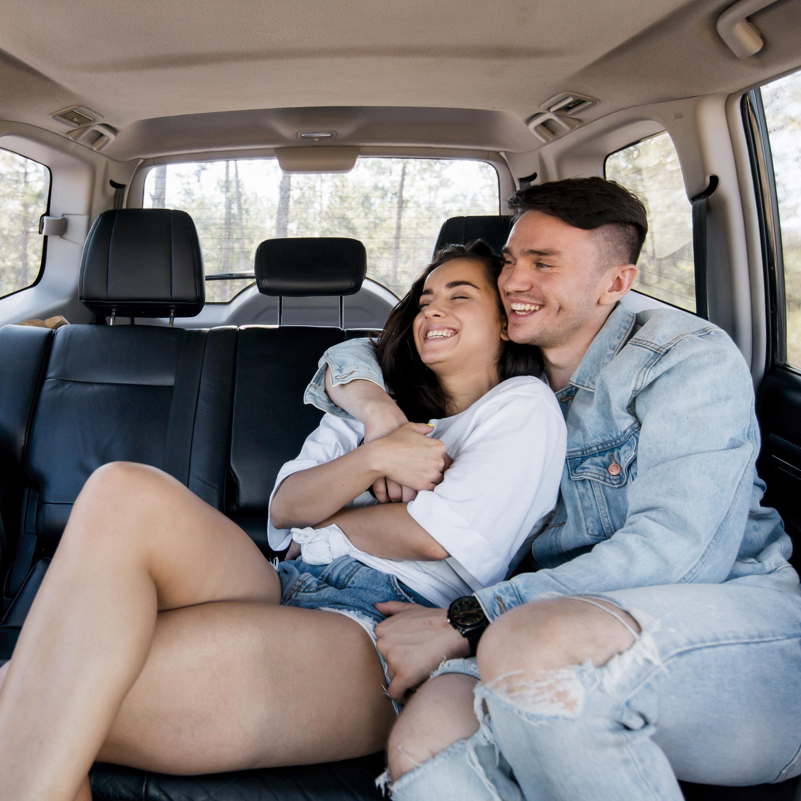 medium-shot-couple-hugging-car