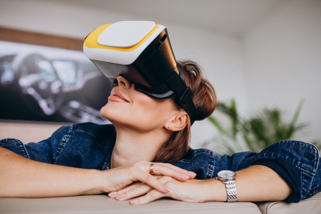 Young woman wearing vr glasses and watching virtual game