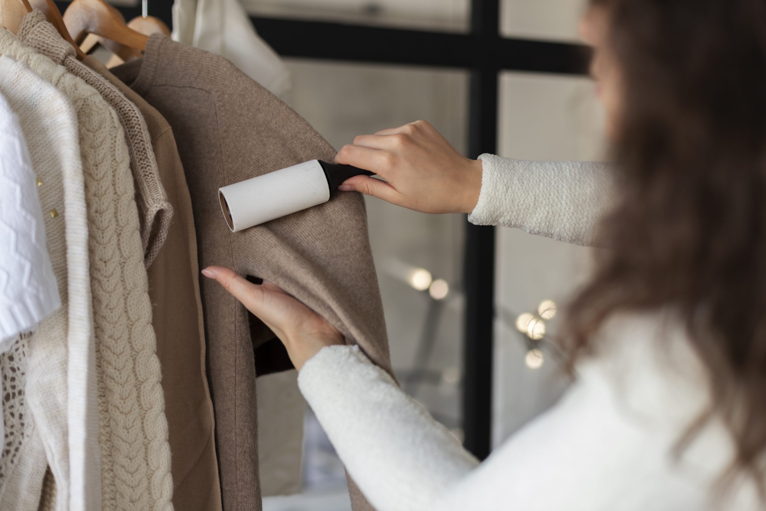 close-up-woman-using-lint-roller