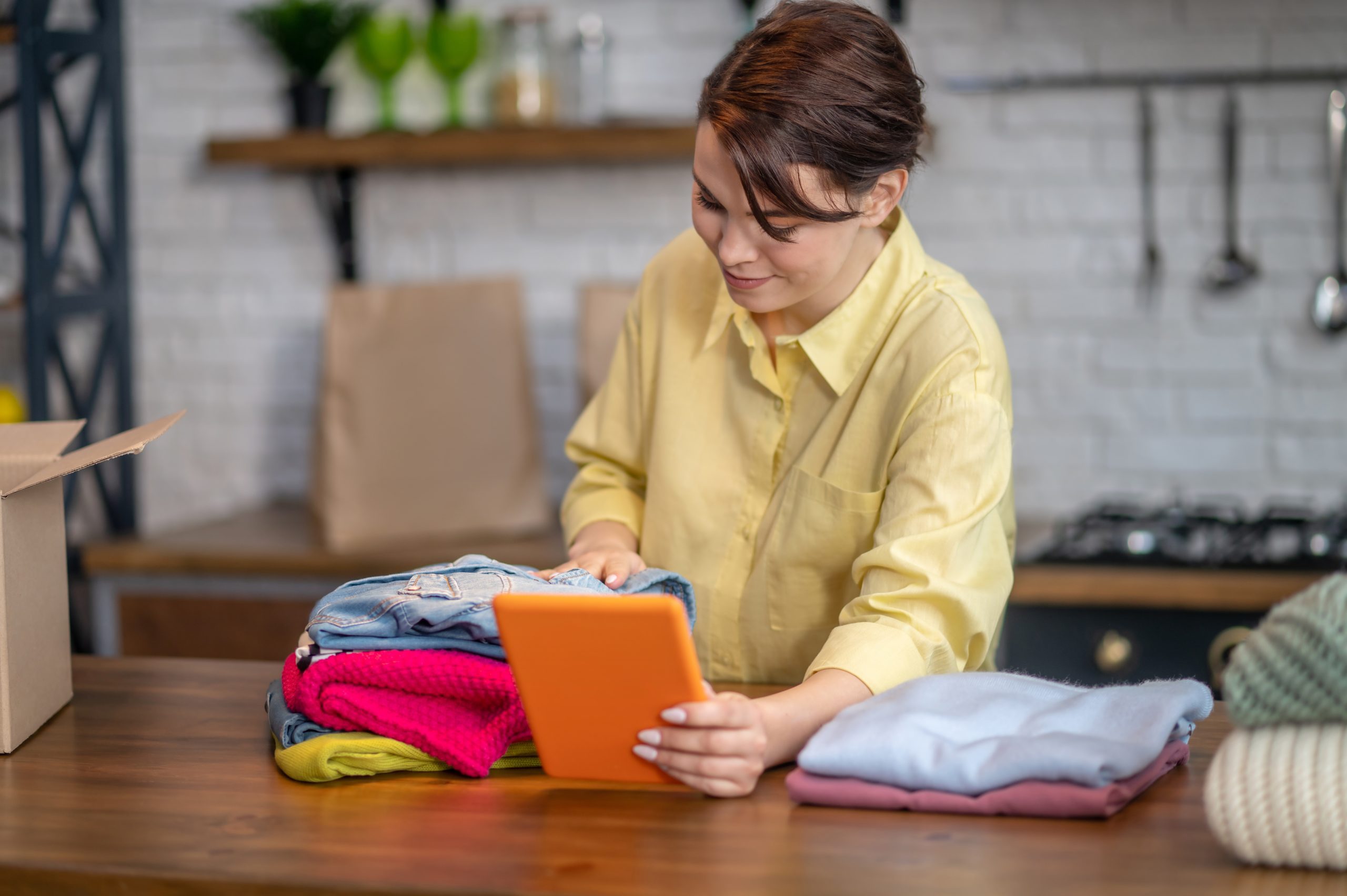 Woman taking photos of items of clothing