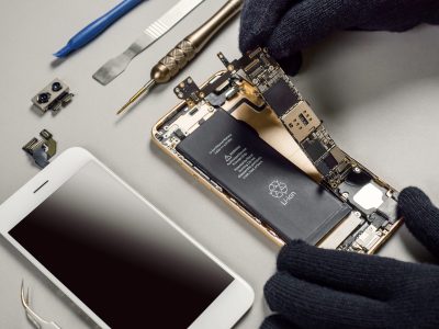 technician-repairing-broken-smartphone-desk-scaled.jpg